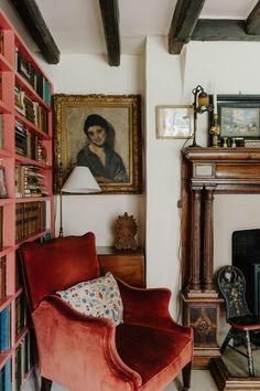 a living room filled with furniture and a fire place in front of a painting on the wall