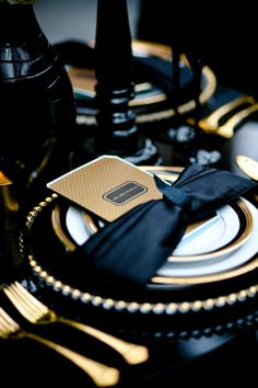 black and gold place setting with white plates