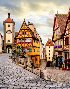 a cobblestone street lined with tall buildings