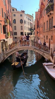 a gondola in the middle of a canal with people on it