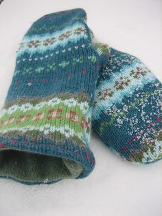 two knitted mittens laying on top of each other