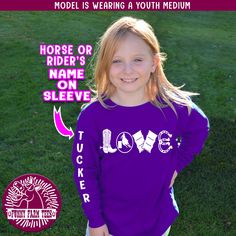 "😊Welcome to Funny Farm Tees and thank you for stopping by to check out our listing😊 Delight the little barrel racer in your life with this adorable long-sleeve personalized t-shirt! This long sleeve t-shirt is complete with any name you want printed on the sleeve in white lettering! This premium quality GILDAN heavy cotton t-shirt will become your horse kiddo's favorite shirt! HOW TO ORDER: 1. Select your desired size from the \"T-SHIRT SIZE\" drop down menu. Please refer to the size chart pr Fitted Long Sleeve Top With Name Print, Casual Long Sleeve Shirt With Name Print, School Spirit Long Sleeve Shirt With Letter Print, Long Sleeve School Spirit Shirt With Letter Print, Purple Crew Neck Top With Name Print, Barrel Racing Shirts, Farm Tees, Horse Hoodies, Funny Farm