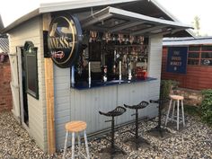 an outdoor bar with three stools and a sign that says miss's on it