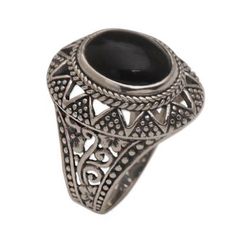 Centered by an oval of dark onyx this Balinese cocktail ring features an original design by Made Sugi. The ring is crafted of sterling silver featuring openwork floral motifs at the band with dotted triangle motifs around the crown. Black Oval Ring With Intricate Design, Black Oval Rings With Intricate Design, Ornate Black Oval Ring, Black Oval Filigree Ring, Silver Oval Ring, Rings Sterling Silver, Silver Cocktail, Oval Ring, Ring Oval