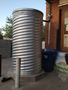 a large metal tank sitting next to a building