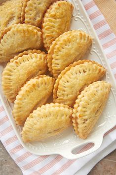 several small pastries on a white plate with a pink and white checkered napkin