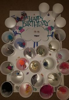 a birthday card with lots of bowls and spoons on the table next to it