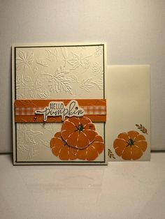 two cards with pumpkins on them, one is white and the other is orange