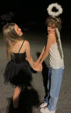 two young people holding hands in the dark