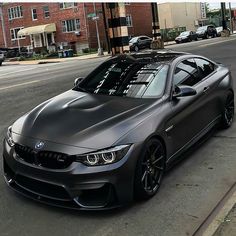 a grey car parked on the side of a street