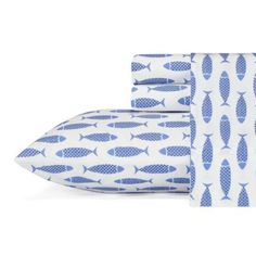 two pillows with blue fish on them are next to each other and one pillow has been folded