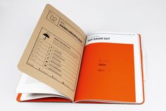 an orange book opened on top of a white table