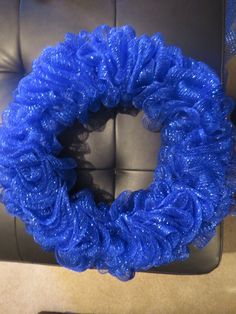 a blue wreath sitting on top of a couch