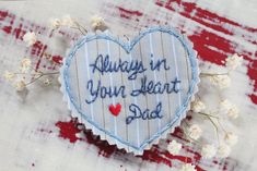 an embroidered heart with the words always in your heart dad on it next to flowers