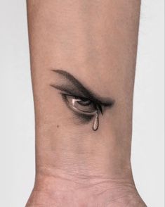 a woman's foot with an eye tattoo on it