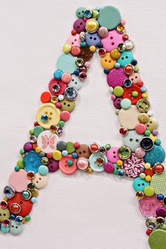 the letter is made up of buttons and other things