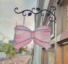 a pink bow hanging from the side of a building