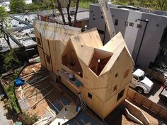 an aerial view of a house being built on top of a building under construction in the city