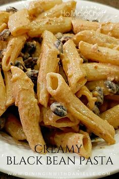 a white plate topped with pasta and mushrooms