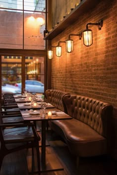 an empty restaurant with long tables and benches