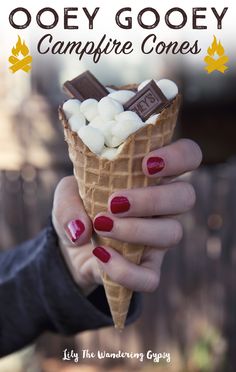 a woman holding an ice cream cone with marshmallows in it and text overlay that reads, ooey gooey gooey campfire cones