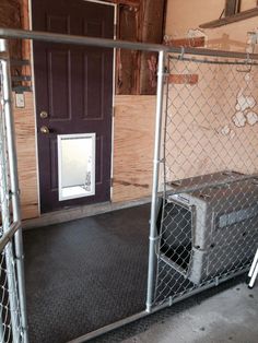 a dog kennel in front of a purple door