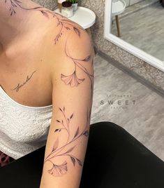 a woman with a flower tattoo on her arm