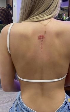 a woman with a rose tattoo on her back