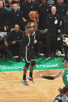 the basketball player is trying to dunk the ball in front of the other team