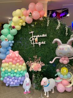 there are many balloons in the shape of animals and bunny's ears on display