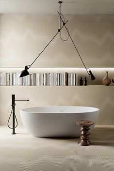 a bath tub sitting in the middle of a bathroom next to a book shelf filled with books