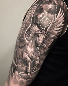 a man's arm with an angel and horse tattoo on it