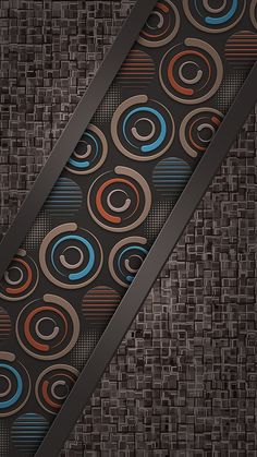 a close up of a tie on a brown background with blue, orange and black circles