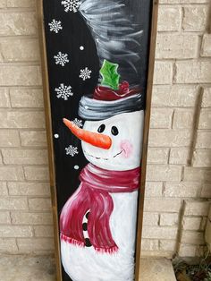 a painted snowman with a hat and scarf