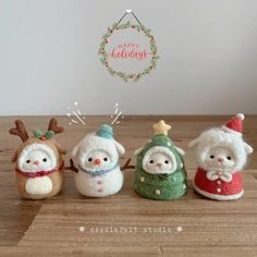 three small knitted snowmen sitting next to each other