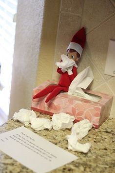 an elf is sitting on top of a box