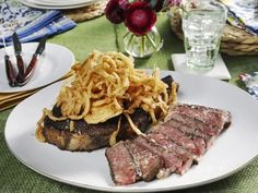 steak and onion rings on a white plate