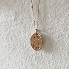 Gold oval pendant engraved with a nude female line drawing. Goddess Of Marriage, Second Piercing, Dream Engagement, Dream Engagement Rings, Ring Sizer, Greek Goddess, Recycled Metal, Dream Ring, Ring Necklace