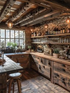 a rustic kitchen with wooden cabinets and shelves filled with bottles, wine glasses, and other items