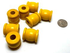 small yellow wooden bead caps on a white surface