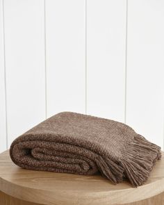 a brown blanket sitting on top of a wooden table