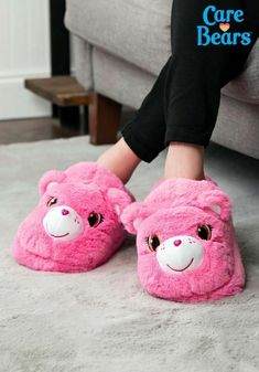 The Care Bears make everything cozy, don't they? Just one look at Cheer Bear and her joyous face can warm your heart when you're feeling down (that's sort of her thing). But now, the fuzzy pink bear can help you keep your toes warm too! That's right, these Cheer Bear Slippers will have your feet feeling terrific with just a little bit of help from the most optimistic bear in all of Care-A-Lot. These slippers will keep your feet cozy with a layer of plush material on the exterior. Of course, it'l Fun Pink Indoor Slippers, Care Bears Cheer Bear, Kids Cheering, Slippers For Kids, Cheer Bear, Bear Slippers, Bear Costume, Faux Fur Material, Dream Fashion