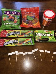 candy bars, marshmallows, and other snacks are arranged on a table