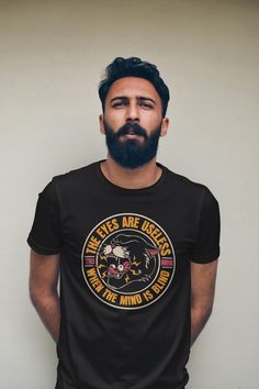 a bearded man wearing a black t - shirt with an image of a lion on it