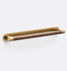 a brass and wood drawer handle on a white background