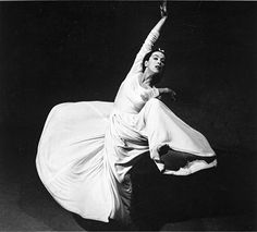 a black and white photo of a woman dancing