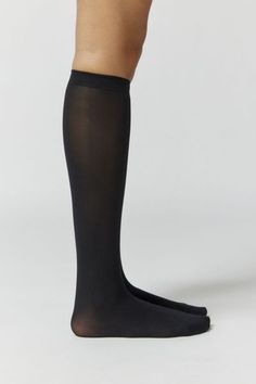 Essential knee highs in the softest sheer knit. Content + Care 96% Nylon, 4% spandex Hand wash Imported Size + Fit Knee length | Classic Sheer Knee High Sock in Black, Women's at Urban Outfitters