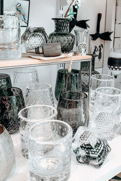 many different glass vases on a table