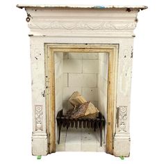 an old fireplace with some wood in it