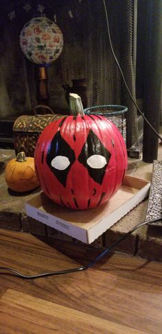 a decorated pumpkin sitting on top of a box